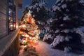 This Snow Covered Christmas Tree stands out brightly against the dark blue tones of late evening light in this winter holiday sce