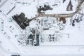 Snow-covered construction site with crane and heavy construction machines. drone photo Royalty Free Stock Photo