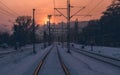 Snow covered empty train tracks at sunset Royalty Free Stock Photo