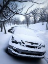 Car in winter snow parked in forest