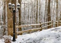 Snow covered fence and light post in winter Royalty Free Stock Photo