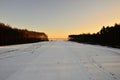 Snow-covered field between forests at the edge of the frame Royalty Free Stock Photo