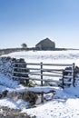 Snow covered field, gate, dry stone wall and barn, Yorkshire Dales in winter Royalty Free Stock Photo