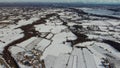 Aerial drone shot of all fields covered with snow in winter, Snow-covered fields of small settlements