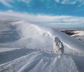 Snow covered fir trees on snowy mountain plateau, tops with snow cornices in far. Magnificent sunny day on picturesque beautiful