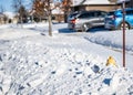 Snow covered fire hydrant with marker on residential street. Royalty Free Stock Photo