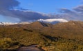 Snow Covered Four Peaks Mountain Range and Forest Road Near Sunset Royalty Free Stock Photo