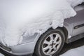 Snow-covered frozen car covered with snow. Winter road. Danger of winter driving. Car snow removal. Dangerous traffic situation Royalty Free Stock Photo