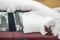 Snow-covered frozen car covered with snow. Winter road. Danger of winter driving. Car snow removal. Dangerous traffic situation Royalty Free Stock Photo