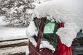 Snow-covered frozen car covered with snow. Winter road. Danger of winter driving. Car snow removal. Dangerous traffic situation Royalty Free Stock Photo