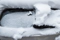 Snow-covered frozen car covered with snow. Winter road. Danger of winter driving. Car snow removal. Dangerous traffic situation Royalty Free Stock Photo