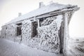 snow covered frozen hut in mountains in winter Royalty Free Stock Photo