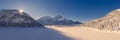 snow-covered frozen lake heiterwangersee in winter with morning sun on the mountain ridge