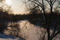 snow-covered frozen winter river on a frosty winter day at sunset with shadows. Royalty Free Stock Photo