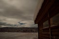 Snow covered garage in winter with mountain and field background at night