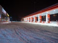 Snow-covered gas station on a winter night. Royalty Free Stock Photo