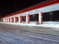 Snow-covered gas station on a winter night. Royalty Free Stock Photo