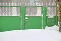 Snow covered gate in the poor village Royalty Free Stock Photo