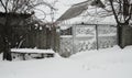 Snow covered gate in the poor village Royalty Free Stock Photo