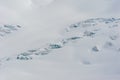 Snow covered glacier crevasses and seracs in snow field