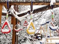 Snow-covered handholds on monkey bars at kids playground