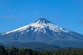 Snow covered hight volcano summit above the forest Royalty Free Stock Photo