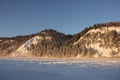 Snow-covered hills, evergreen trees on the slopes, in the sunset. Lots of snow and frost trees.