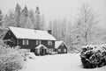 Snow covered house in forest