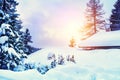 Snow-covered house in winter forest at sunset Royalty Free Stock Photo