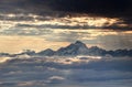 Glowing sun rays above snowy Julian Alps and sea of clouds Royalty Free Stock Photo