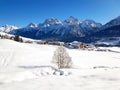 Fairytale winter landscape with snow-covered fields and Swiss Alps under a deep blue sky in the Ftan Engadin, Switzerland Royalty Free Stock Photo
