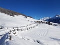 Fairytale winter landscape with snow-covered fields and Swiss mountains under a deep blue sky in the Engadin, Switzerland Royalty Free Stock Photo