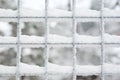 Snow covered latticed fence