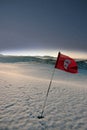 Snow covered links golf course flag at night Royalty Free Stock Photo