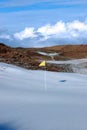 Snow covered links golf course with yellow flag