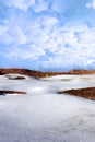 Snow covered links golf course with yellow flag