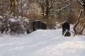 Snow covered little bridge in winter park