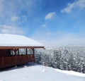 Snow Covered Log Cabin Looking Over The Winter Horizon Royalty Free Stock Photo