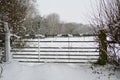 Snow covered metal gate leading into a field Royalty Free Stock Photo