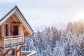 Snow covered modern chalet in Alps mountains with winter forest landscape, beautiful Christmas destination Royalty Free Stock Photo