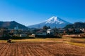 Snow covered Mount Fuji and local town along train route in Shimoyoshida - Fujiyoshida, Japan Royalty Free Stock Photo