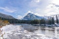 Snow-covered Mount Rundle, drift ice floating on Bow River in winter. Canadian Rockies, Alberta, Canada. Royalty Free Stock Photo
