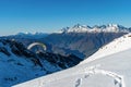 Snow covered mountain with flighting skydiver Royalty Free Stock Photo