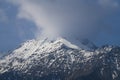 Snow covered mountain with peak hidden by a cloud. Northern Caucasus Royalty Free Stock Photo