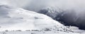 Snow Covered Mountain Peak during snowy winter day. Royalty Free Stock Photo