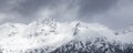 Snow Covered Mountain Peak during snowy winter day. Royalty Free Stock Photo