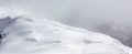 Snow Covered Mountain Peak during snowy winter day. Royalty Free Stock Photo