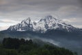 Snow covered mountain peak of Watzmann at Berchtesgaden with clouds and morning fog during sunrise, Bavaria Royalty Free Stock Photo