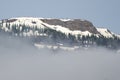 Snowy Mountain Peaks Standing Above the Clouds Royalty Free Stock Photo