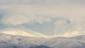 Snow covered mountain peaks in sunset. Location is Tarcu Mountains in Romania Royalty Free Stock Photo